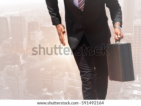 Digital composite image of businessman walking with a suitcase against cityscape in the background