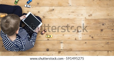 Kid playing with his tablet header image