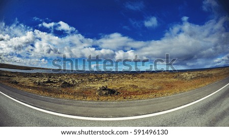Travel to Iceland. Beautiful Icelandic landscape with road, sky and clouds. Trekking in national park Landmannalaugar
