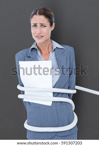 Businesswoman tied up in rope against grey background