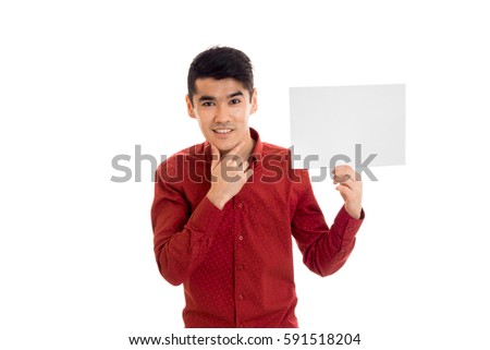 handsome young brunette man posing with empty placard in his hands and smiling, isolated on white background