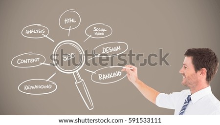 Digitally composite image of businessman writing business term on chalkboard