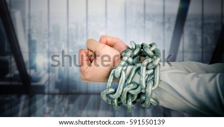 Digitally composite image of businessman hands bound in chains