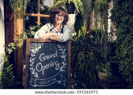 Adult Woman Standing with Grand Opening Sign