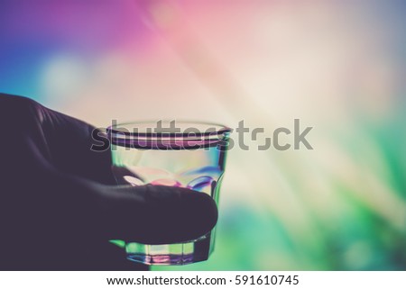 Holding a shot glass (vintage effect)