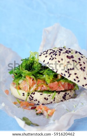 Fish burger with salmon tartare and wakame Hiashi on a steam bun