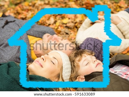 Digitally generated image of family relaxing on dry leaves with house model