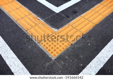 braille block on tactile paving for blind handicap on tiles pathway
