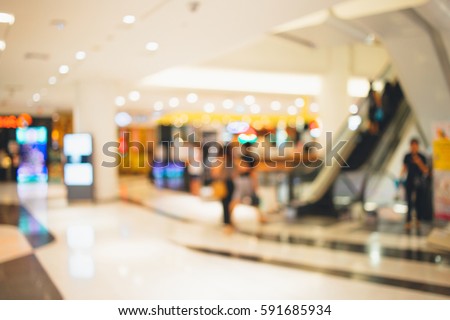 Abstract blurred photo of shopping zone background,Blurred of people walking in shopping mall:blur of department store indoors,blurred of shopping mall.vacation weekend day  Royalty-Free Stock Photo #591685934