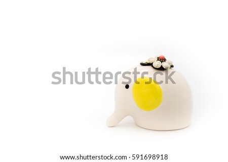 White ceramic elephant with yellow pinna and the rock flower above head isolated on white background.