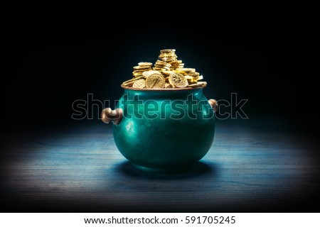 gold coins in a green pot on a dark background