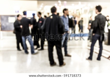 Blur image of a lot of people talk in front of the meeting room.(On vintage tone)