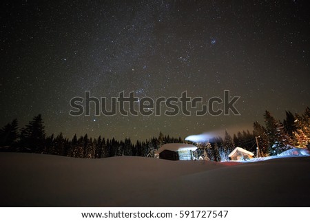 Little House on the background of the starry winter sky