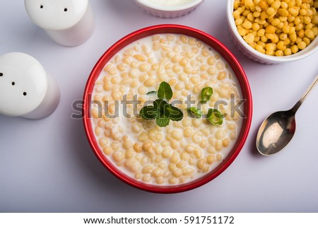 Dahi Bundi or Boondi Raita with curd, is a Popular side dish from Rajasthan, India. Served with coriander toppings in a bowl over colourful or wooden background. Selective focus Royalty-Free Stock Photo #591751172