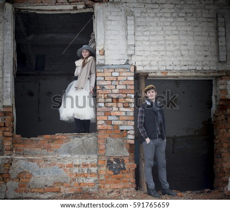 Happy couple in love on a date in the ruins old factory. Vintage style.