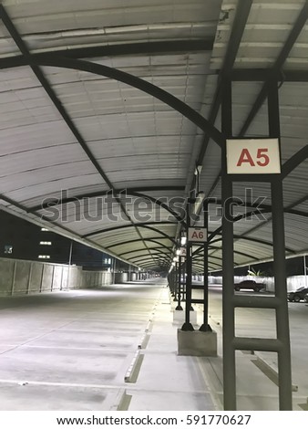 Empty outdoor car park with roof in the night blur background