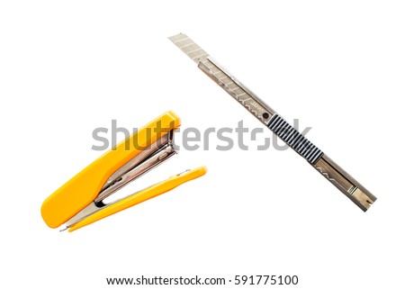 Stapler and silver cutter on white background