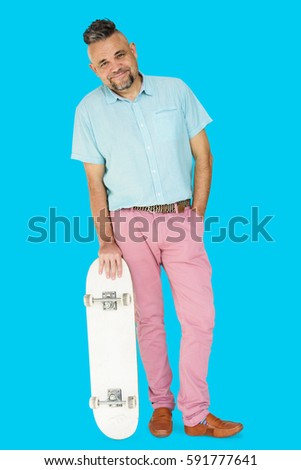 A Man Standing Holding Skateboard