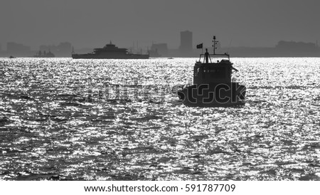 black-and-white photo of boats in the sea of Marmara in the back light