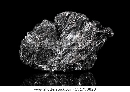 Rough mineral stone of Graphite, black specimen carbon, black background Royalty-Free Stock Photo #591790820