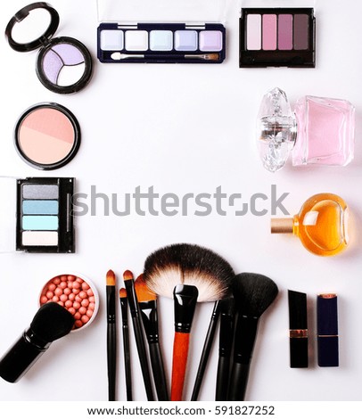 make-up brush, perfume, eye shadow, blush on the white background