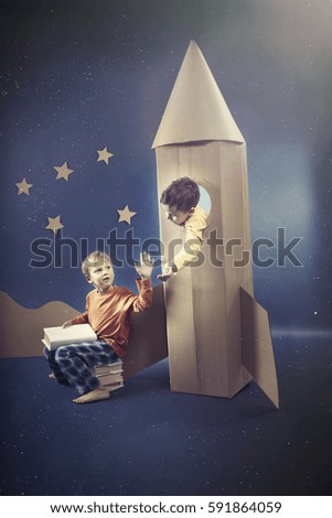 Little boy in the rocket on the night sky background