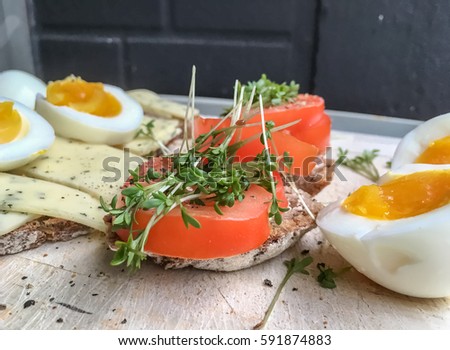 Cheese sandwich with eggs, tomatoes and cress on wholegrain bread. Flat lay on wooden background, image for diet blog, menue cards, restaurants business website, cooking books receipe, social media