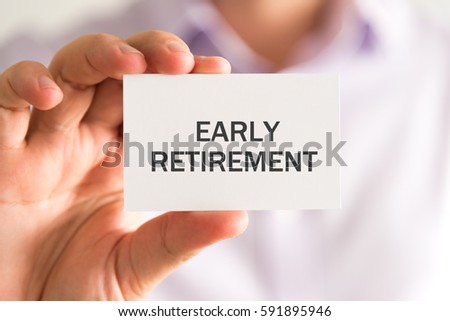 Closeup on businessman holding a card with EARLY RETIREMENT message, business concept image with soft focus background