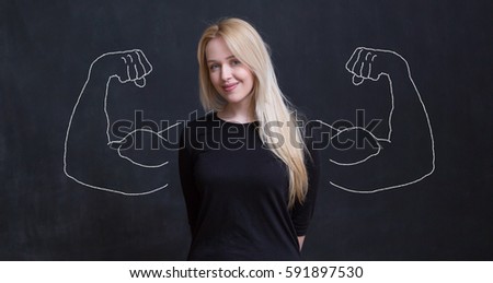 Young woman against the background of depicted muscles on chalkboard