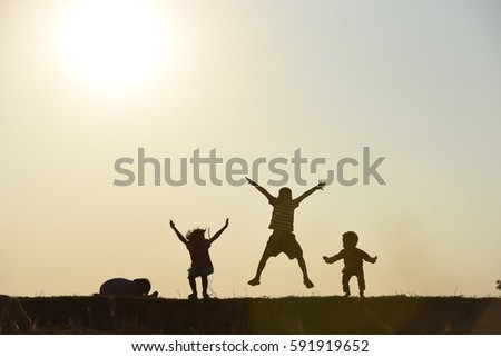 silhouette children jump 
