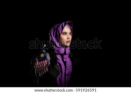 Portrait of a muslim malay teenager wearing climbing costume and gear with copy space isolated on black background
