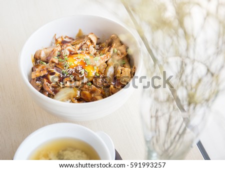 Grilled Beef with japanese ingredient on rice on table with soup