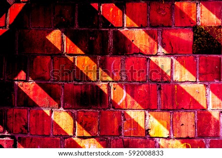fence made with bricks as painted picture with geometric ornament. Diagonal light red lines on dark red background on vintage brick wall. Colorful brick wall pattern, painted bricks as urban texture