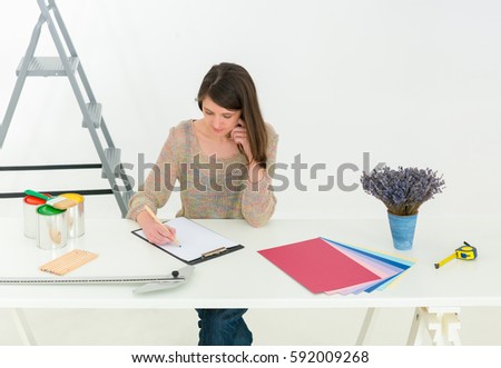 Creative people workplace. Close-up view of brunette young designer woman working with colour palette at office desk. Interior shot. Horizontal photo banner for website header design