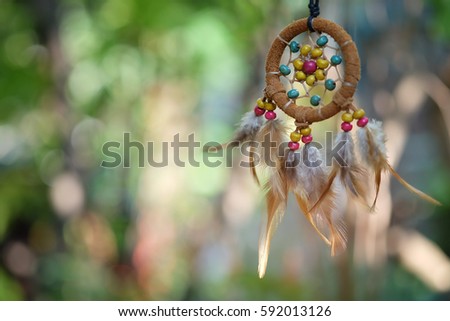 Soft focus dream catcher with natural bokeh background selective focus and blurry. Native american dream catcher. boho chic, ethnic amulet.