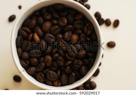 kraft paper coffee cup coffee beans scattered light background