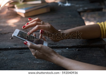 Close up of hands woman using her cell phone  ready to use.