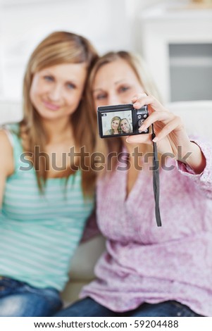 two cute friends taking a picture at home