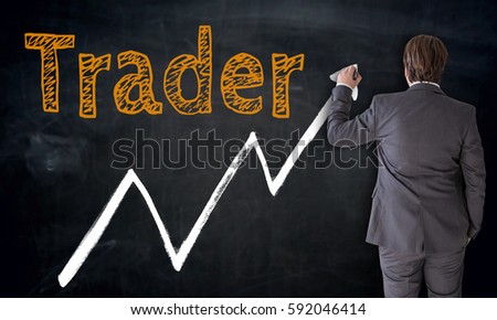 Businessman writing trader on blackboard concept.