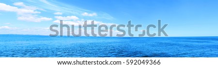 Sea Panorama. Beautiful blue sky and white clouds. Bright colors. Royalty-Free Stock Photo #592049366
