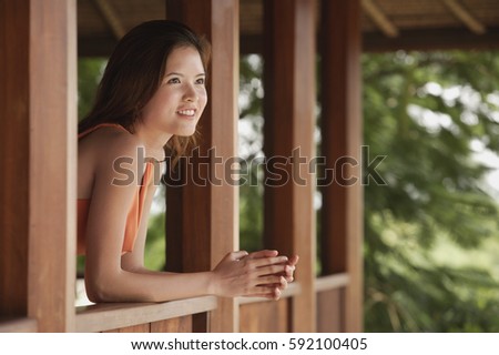 Woman standing in balcony, looking out