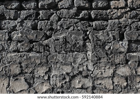 Background image of an old cracked brick wall with remnants of plaster