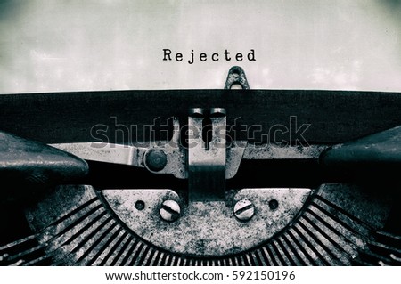 Rejected words typed on a vintage typewriter in black and white. Royalty-Free Stock Photo #592150196