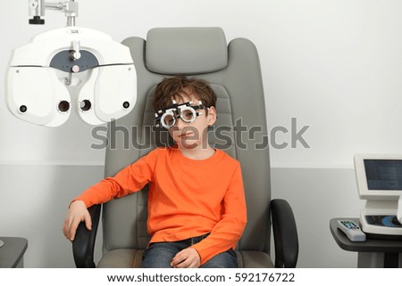 eye examination, Optometrist in exam room with young boy 