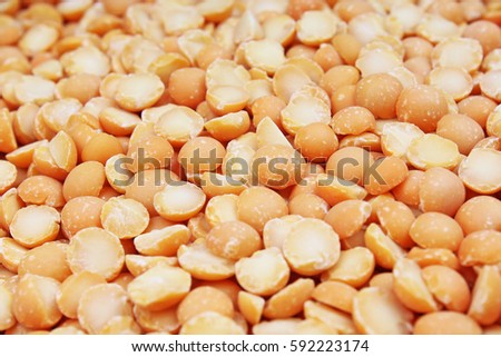 A background of split yellow peas. Yellow peas pea texture background pattern wallpaper. Healthy food. Studio photo texture photography
