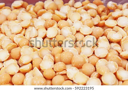A background of split yellow peas. Yellow peas pea texture background pattern wallpaper. Healthy food. Studio photo texture photography
