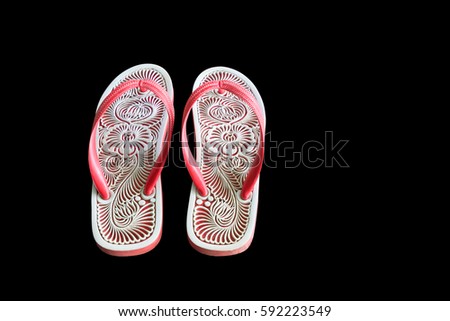 Sandals with carved designs. The pattern on sandals On a black background