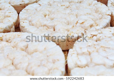 Stack of puffed whole grain crispbread. Rice cake puffed rice texture.Round rice cakes background. Corn crackers. Rice galettes Studio photo texture photography.

