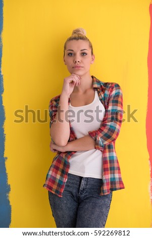 Portrait of a beautiful  young woman with hair bun over color background with copyspace expressing different emotions