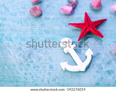 Background with decorative anchors and wheels on a blue wood background. Place for text. Top view with copy space